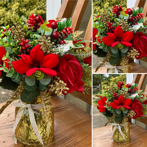 A Christmas artificial handtied flower arrangement in glass vase