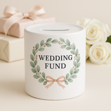 White piggy bank with 'Wedding Fund' text and decorative elements on a light background
