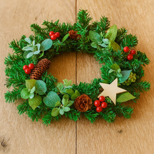 A 33cm pine Christmas wreath with artificial foliage, cones & berries