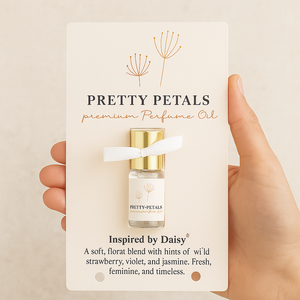 Pretty Petals premium perfume oil packaging held by a hand on a beige background