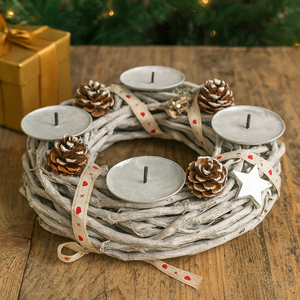Decorative wreath with candles and pine cones on a wooden surface with a Christmas tree in the background.