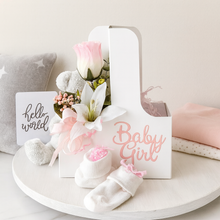 Baby shower gift set with flowers, socks, and 'Hello World' card on a white surface.