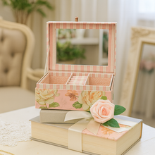 Decorative jewelry box with floral design on a table