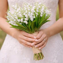 A wedding bouquet of pure white artificial lily of the valley flowers