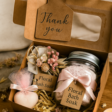 Gift set with floral bath soaks and a 'Thank you' tag, presented in a box.