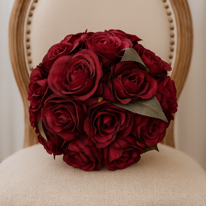 Bouquet of burgundy roses on a beige chair