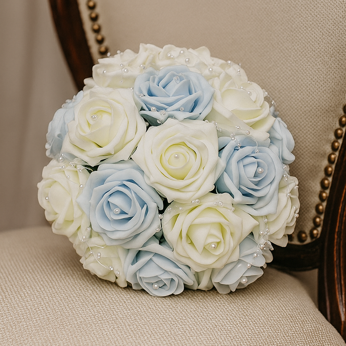 Bouquet of light blue and white roses on a beige chair