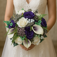 Bride holding a bouquet of purple and white flowers against a neutral background
