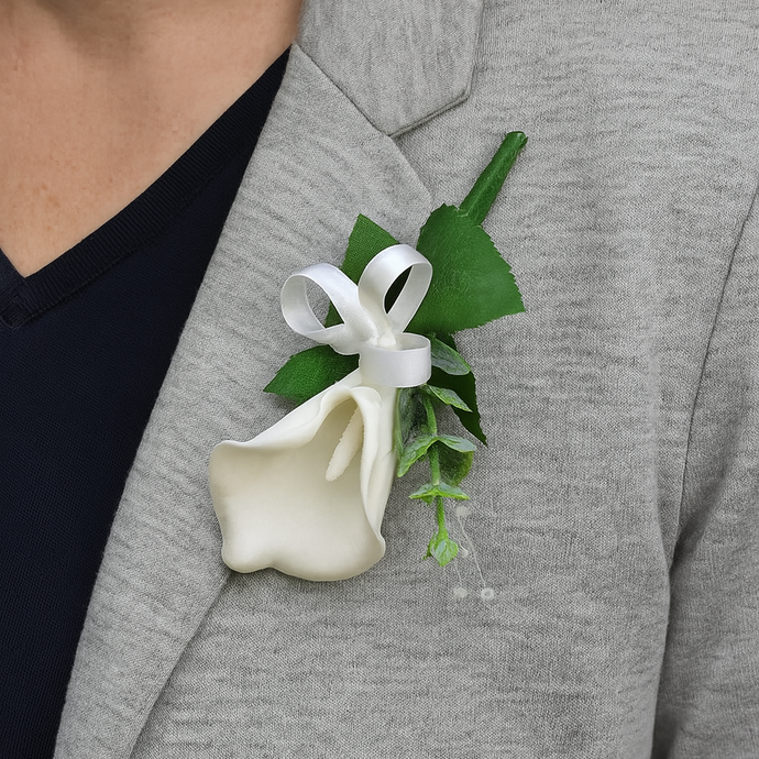 A buttonhole of a white real touch calla lily and bow