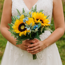 a brides bouquet of sunflowers roses and blue forget-me-nots