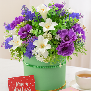 A handtied arrangement of purple and ivory flowers & foliage