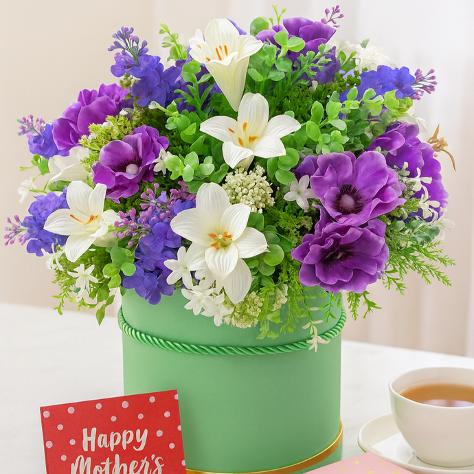 A handtied arrangement of purple and ivory flowers & foliage