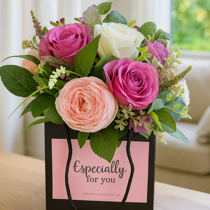 handtied flower bouquet of pink peonies and roses in black box
