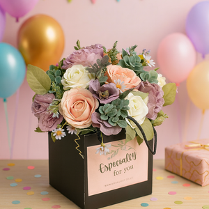 handtied flower bouquet of lilac and pink roses in black box