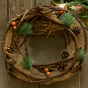Decorative wreath with natural elements on a wooden door