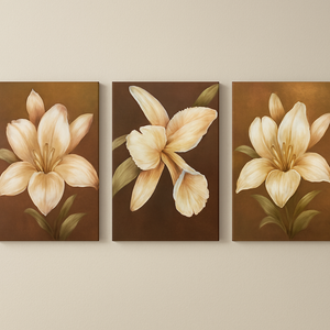 Three floral paintings of beige flowers on brown backgrounds hanging on a wall.