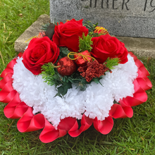 memorial wreath of artificial silk roses in shades of red