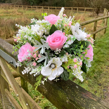 a graveside artificial flower arrangement in shades of cream and pink