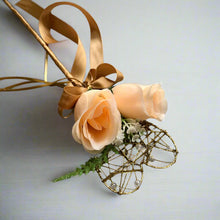 A wedding bouquet featuring silk flowers in shades of ivory and peach