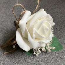 an artificial buttonhole featuring a single foam ivory rose