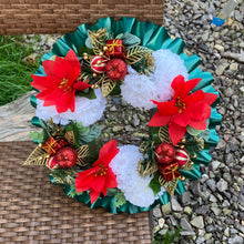 a memorial christmas wreath featuring baubles, cones and poinsettia