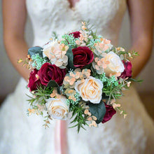 A wedding bouquet of artificial silk burgundy & orange flowers