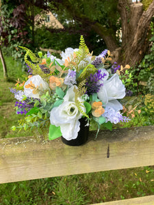 grave pot with flowers featuring artificial silk blooms