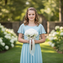 A bridesmaid's wedding bouquet of artificial silk ivory roses