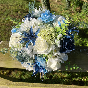 A bridesmaids bouquet of blue & white and ivory silk flowers