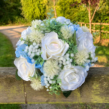 A brides bouquet of white/ivory and pale blue artificial silk flowers