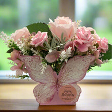 An artificial flower arrangement in butterfly container