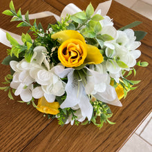 A wedding bouquet collection of yellow and ivory silk flowers