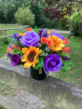 grave pot with faux silk roses and sunflowers