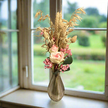 pink dried grasses in glass bud vase