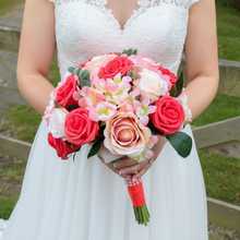 A brides bouquet featuring apricot, coral and peach roses & hydrangea