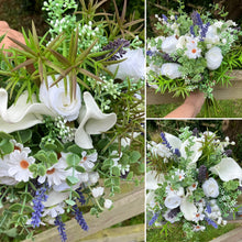 A brides bouquet of white calla, roses, lavender and foliage