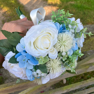 A brides bouquet of white/ivory and pale blue artificial silk flowers