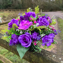 a silk graveside flower arrangement in black pot