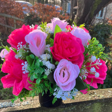 graveside artificial flower arrangement in shades of pink