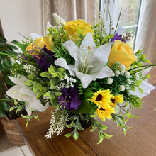 a yellow and purple flower arrangement