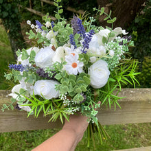 A brides bouquet of white calla, roses, lavender and foliage