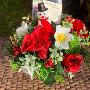 A graveside posy flower arrangement in grave pot