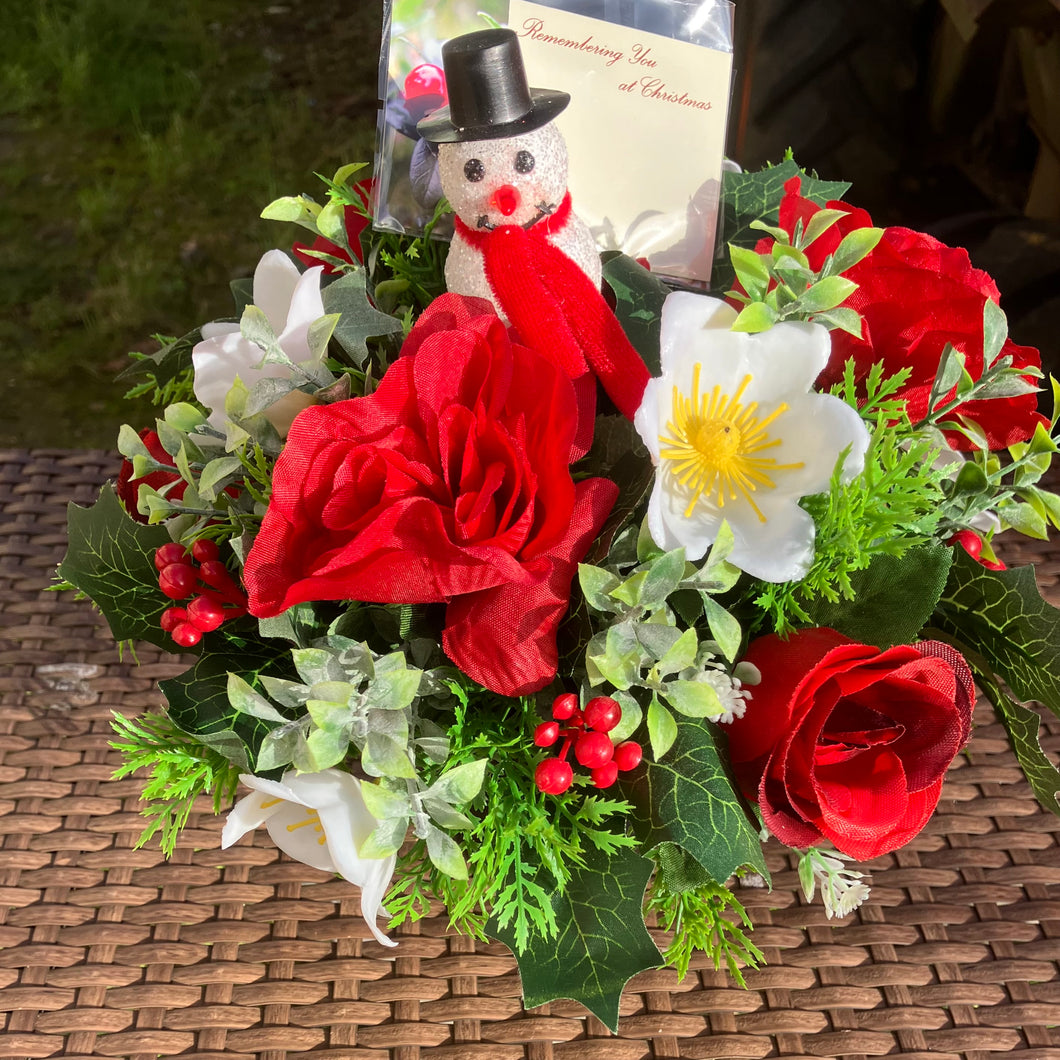 A graveside posy flower arrangement in grave pot