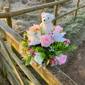 a grave pot with roses and lilies plus flocked teddy