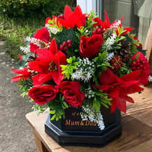 A Christmas memorial flower graveside arrangement