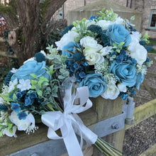 A wedding bouquet collection of ivory and teal flowers and foliage