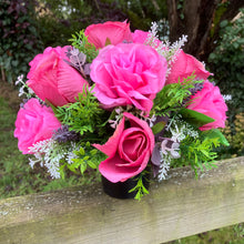 graveside artificial flower arrangement in shades of pink