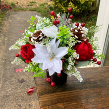 A memorial Christmas flower rose and poinsettia arrangement