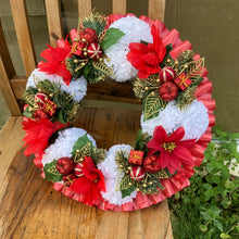 a memorial christmas wreath featuring baubles, cones and poinsettia