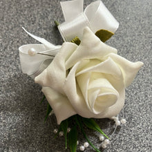 a childs bespoke ivory rose buttonhole  with ribbon bow and pearl loops